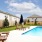 Resort-style swimming pool with lounge chairs at Balcara at Meridiana rental homes