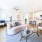 Open-concept living room with large windows and modern design in a Meridiana rental home